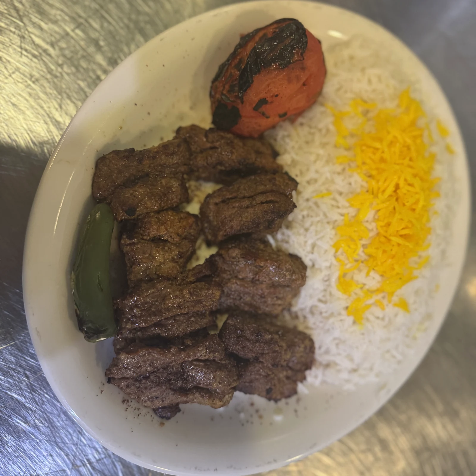 Chenjeh, Beef tenderloin in thick cuts, marinated overnight, charbroiled until the edges catch.